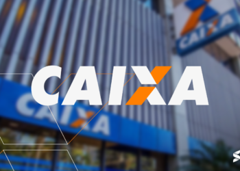 Logotipo da Caixa Econômica com o fundo desfocado de uma agência da Caixa Econômica.