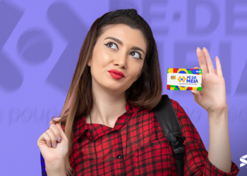 Beneficiária do programa Pé-de-Meia segurando o cartão do programa.