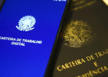 Imagem de um celular exibindo a carteira de trabalho digital ao lado da versão física, destacando a tendência de antecipação de salário via Pix.