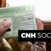 "Imagem de uma pessoa segurando a CNH enquanto está no banco de motorista, com o logo do programa CNH Social."