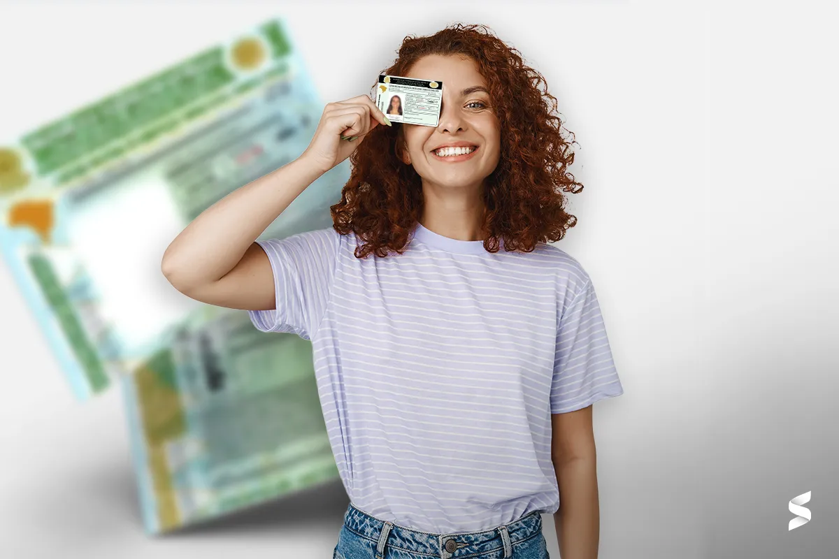 "Jovem segurando a CNH com sorriso, representando a importância de ficar atento às condicionalidades do programa."