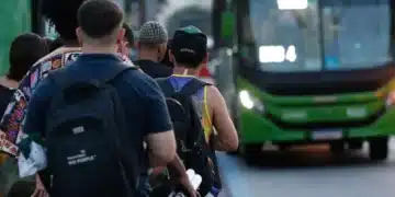 pessoas aguardam ônibus em fila no início do Dia do Trabalho