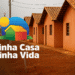 Casas populares com telhado de cerâmica em área rural, representando o programa Minha Casa Minha Vida.