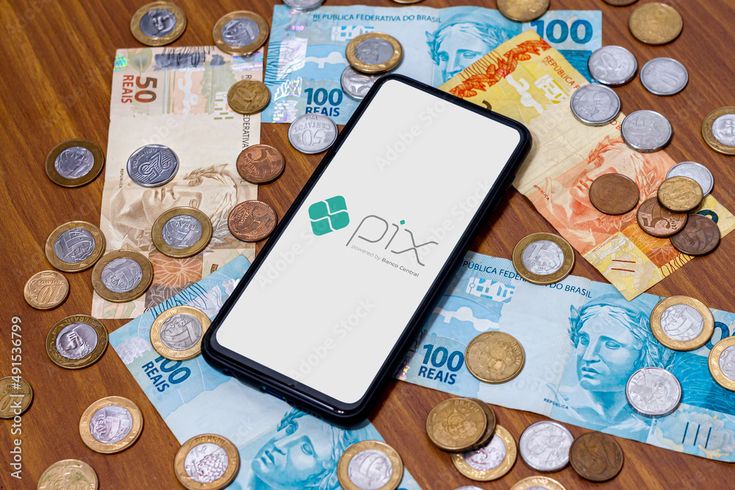 Celular exibindo o logo do Pix cercado por dinheiro em espécie, representando a facilidade de acesso ao salário antecipado via Pix.