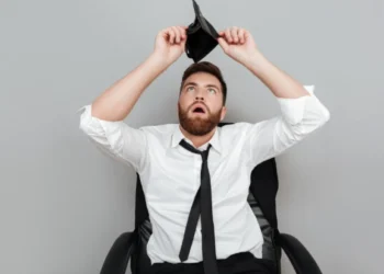 Homem preocupado olhando para carteira vazia, representando a perda de documentos como o CPF.