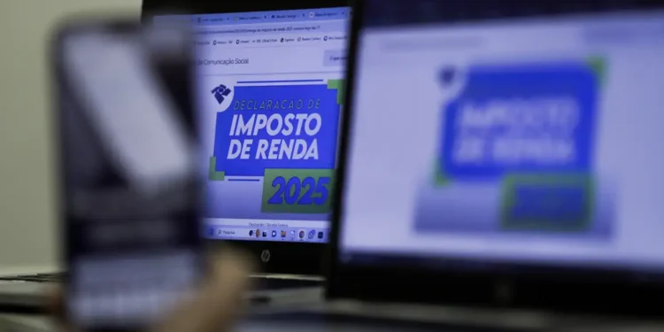 Tela de computador e celular mostrando informações sobre a declaração do Imposto de Renda 2025.
