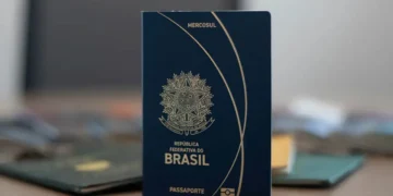 Passaporte brasileiro azul com brasão da República Federativa do Brasil em destaque.