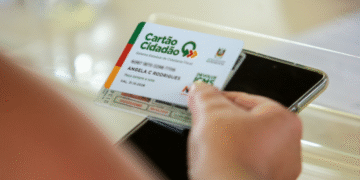 Cartão Cidadão com logo de ICMS ao lado de um celular, ilustrando o processo de devolução do ICMS no estado.