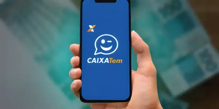 Aplicativo Caixa Tem exibido em smartphone com fundo de cédulas de R$ 100, relacionado ao pagamento do PIX de R$ 600 em julho.