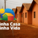 Logo do programa Minha Casa Minha Vida com imagem de casas populares e fundo com céu e postes.