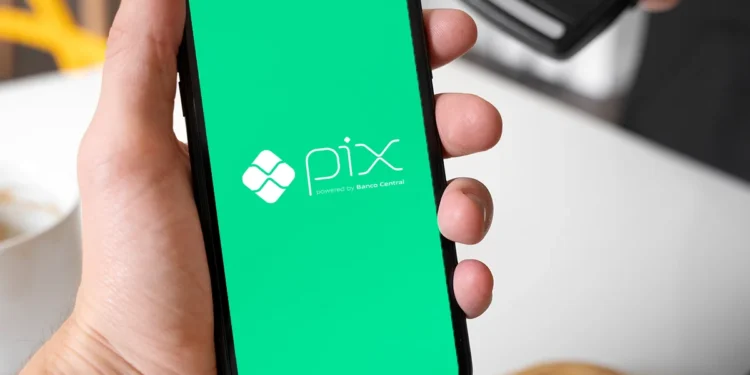 Imagem representando o Pix no celular com fundo verde e o logo do Pix, importante para entender novas regras do sistema de pagamentos no Brasil.