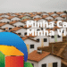 Conjunto de casas populares com telhados laranja e texto Minha Casa Minha Vida