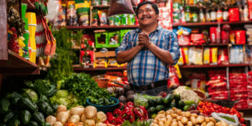 Comerciante em mercado, com legumes e verduras, diante de proposta de projeto de lei sobre comércio aos domingos e feriados.
