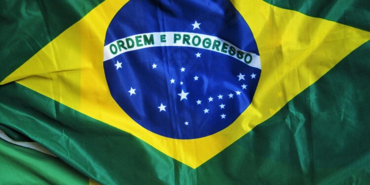 Close-up da bandeira do Brasil com a frase "Ordem e Progresso" e as estrelas visíveis, simbolizando a celebração da Independência no dia 7 de setembro.