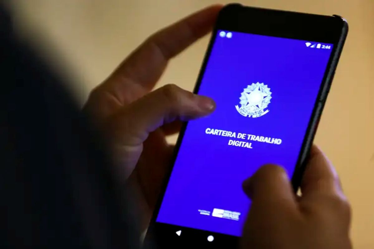 Pessoa segurando um smartphone com o aplicativo da Carteira de Trabalho Digital aberto, ilustrando a modernização do acesso ao crédito.