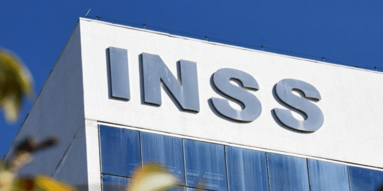 Fachada de prédio do INSS com o nome em destaque contra céu azul