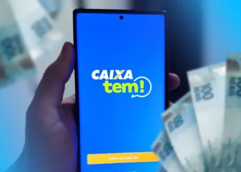 Aplicativo Caixa Tem aberto com notas de 100 reais ao fundo, relacionado ao PIX de R$200 entre 27/10 e 03/11.