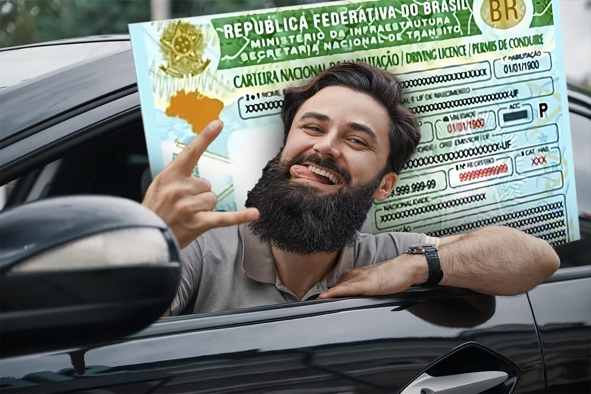 Homem barbudo e sorridente dentro de um carro, fazendo um sinal de 'rock', com a Carteira de Habilitação (CNH) em plano de fundo.
