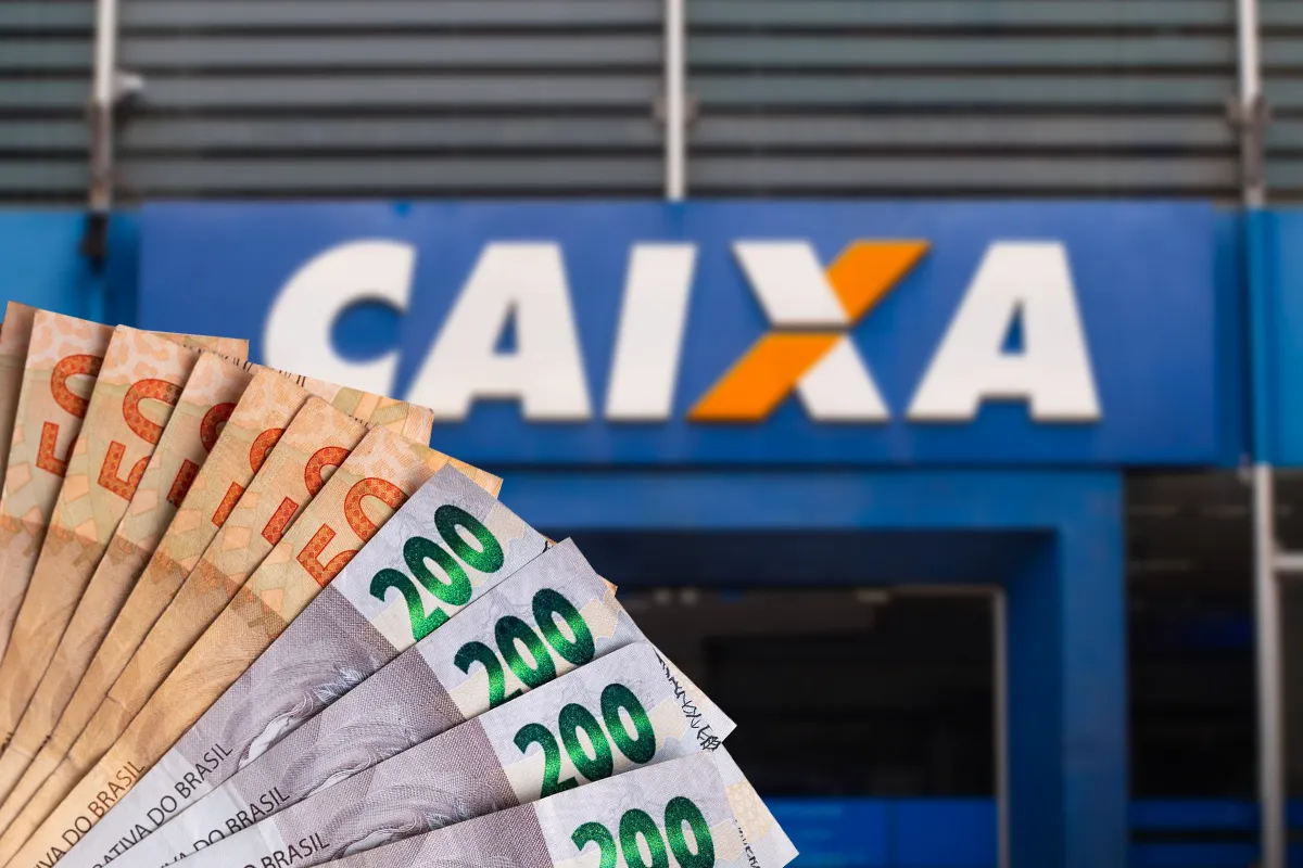 Notas de reais em frente a uma agência da CAIXA, representando o Saque Calamidade do FGTS.