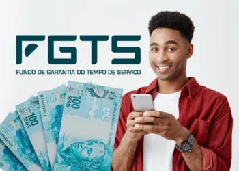 Homem sorridente segurando celular com notas de cem reais ao lado e logo do FGTS ao fundo