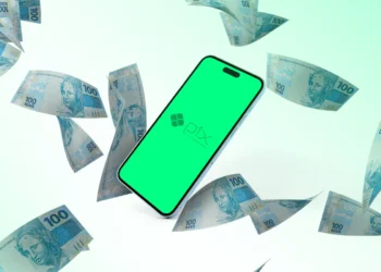Smartphone exibindo o logotipo do Pix em uma tela verde, cercado por notas de 100 reais flutuando, representando transações financeiras e impostos.