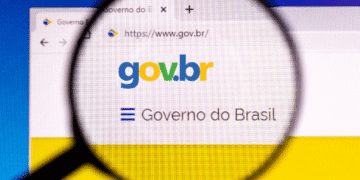 Logotipo gov.br em uma página web com lupa ampliando a visualização.