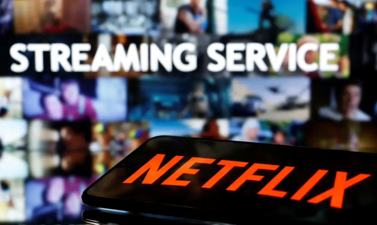 Tela de celular com o logo da Netflix em primeiro plano, sobreposta a uma TV com a frase 'STREAMING SERVICE' e várias cenas de filmes, representando as alternativas legais ao IPTV pirata.