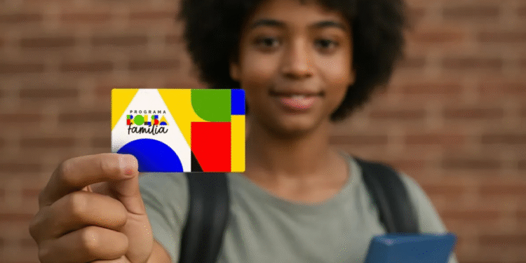 Pessoa segurando um cartão do programa Bolsa Família.