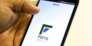 Pessoa acessando o aplicativo do FGTS no celular.