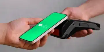 Celular com tela Pix sendo aproximado de uma maquininha NFC