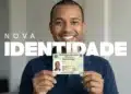 Homem sorridente segura Carteira de Identidade Nacional (CIN) verde com brasão do Brasil e dados pessoais.