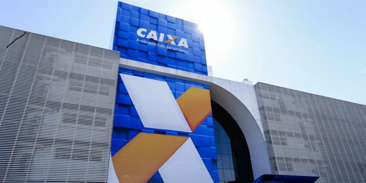 Fachada azul de agência Caixa Econômica Federal com logo X estilizado em branco e laranja contra céu azul.