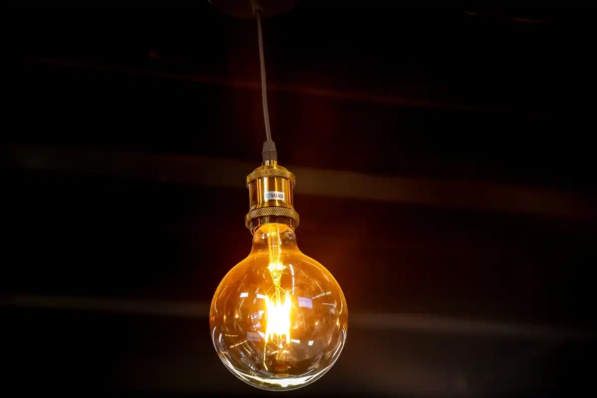 Agosto com bandeira amarela: descubra quanto a mais você vai pagar na conta de luz 2 Lâmpada acesa representando geração de energia elétrica e os fatores que influenciam a aplicação da bandeira amarela