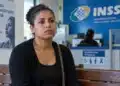 Mulher aguardando atendimento em uma agência do INSS, representando o benefício por afastamento do trabalho em decorrência de violência doméstica.