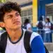 Síndrome de Tourette passa a contar como deficiência; veja o que muda no acesso ao BPC e na escola 14 Estudante em frente a uma escola pública, representando o reconhecimento da Síndrome de Tourette como deficiência.